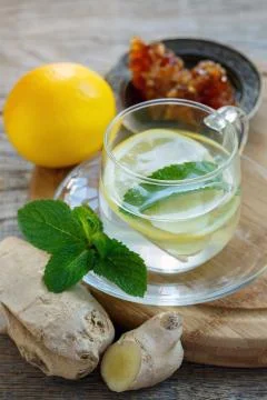 Hot drink with ginger, lemon, mint and honey. Stock Photos