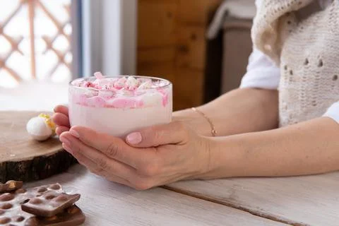 Hot drink with marshmallows on a wooden table. Stock Photos