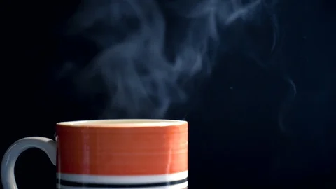 Hot drink with steam on a back background 4k Stock Footage 121668457