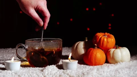 Hot drink of tea in autumn pumpkin scene Stock Footage 256805968