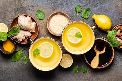 Hot drinks with ginger, lemon and mint in a cups. Stock Photos
