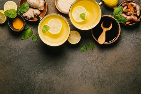 Hot drinks with ginger, lemon and mint in a cups. Lemon, ginger, honey, and t Фото