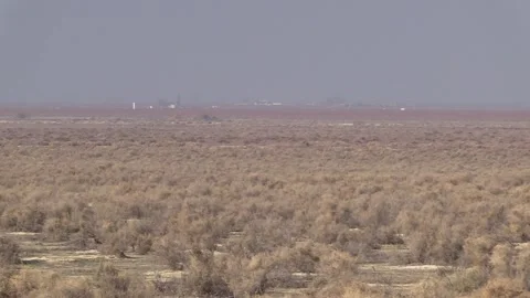 Hot Dusty Dry Desert Sagebrush Habitat in California Oil Development in Distance Stock Footage