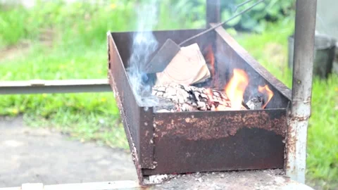 Hot empty barbecue BBQ grill with flaming fire and ember charcoal. Stock Footage 130968333