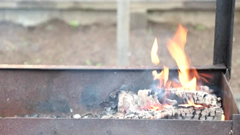 Hot empty barbecue BBQ grill with flaming fire and ember charcoal.  Close up Stock Footage 130968348