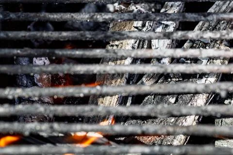Hot empty barbecue BBQ grill with flaming fire and ember charcoal Stock Photos