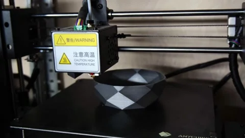 Hot end of 3d printer applies plastic to make cup in shop Stock Footage 140655361