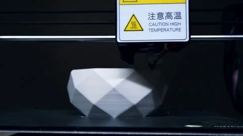 Hot end of 3d printer moves to make white cup with plastic 動画素材 140655308