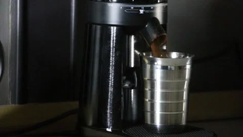 Hot espresso streams from a professional espresso machine portafilter. Video stock 309646136