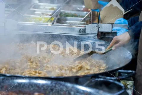 Hot food being prepared on a market stall in London Stock Photos