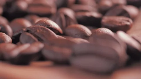 Hot fragrant roasted coffee beans on wooden background Vídeo Stock 150168788