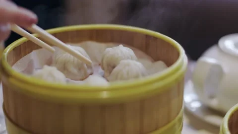 Hot fresh steaming dim sum, Chinese restaurant, eating delicious food, dumplings Stock Footage 204101836