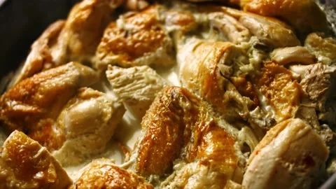Hot freshly cooked big oven roasted chicken stewed in spiced sauce. Process of Stock Footage 151431379