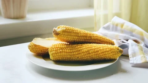 Hot freshly cooked hot corn cobs in a plate Stock Footage 162568390