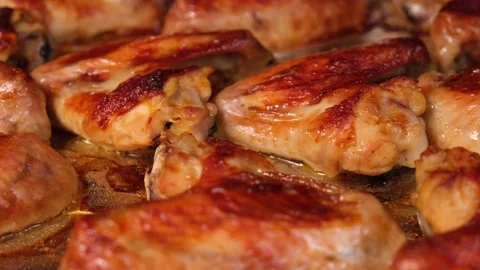 Hot fried appetizing grilled chicken wings Stock Footage 194504028