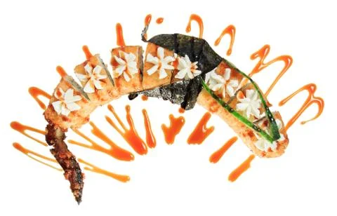 Hot fried sushi rolls in the shape of a dragon. Isolated on white background. Stock Photos
