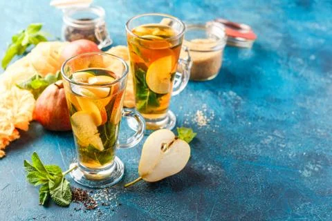 Hot fruit tea with ripe pears and mint Stock Photos