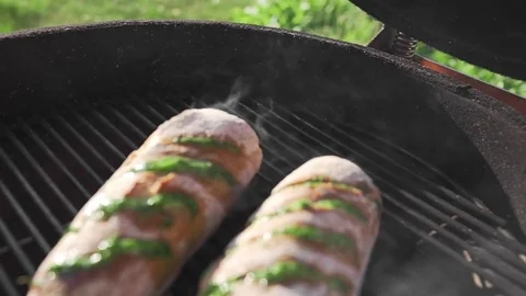 Hot garlic bread with smoke and fire on the grill in the sunset sunlight at the Stock Footage 77517844
