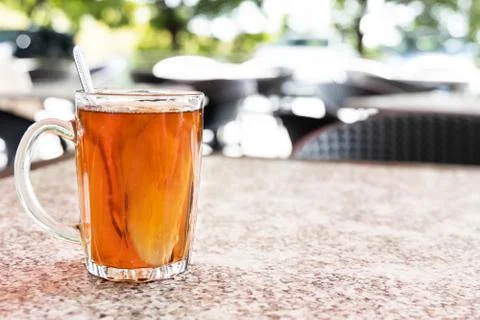 Hot ginger root tea in transparent glass good for health Stock Photos
