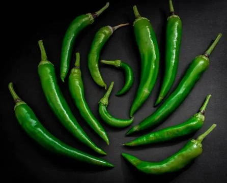 Hot green pepper on black background. top view Stock Photos