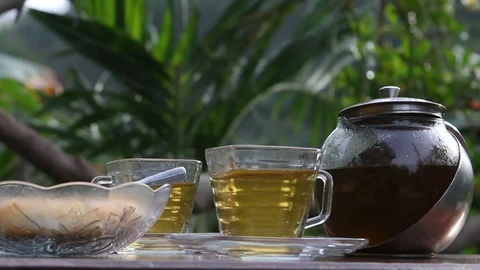 Hot green tea from the tea pot That was pouring in the cup Stock Footage 120355953