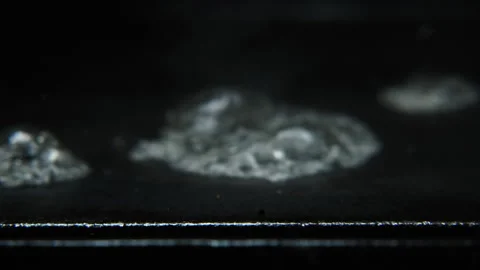 Hot griddle with water falling out of focus and creates steam and noise audio Stock Footage 246555497