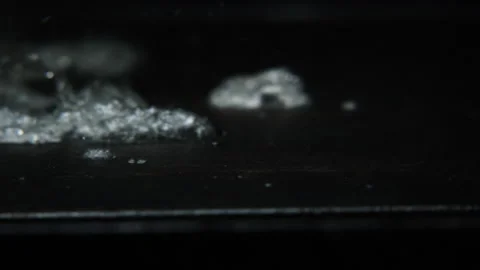 Hot griddle with water that falls and creates steam and noise and drops audio Stock-Footage 246554448