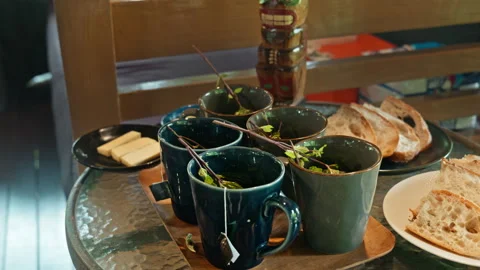 Hot herbal mint tea drink in mugs over wooden tray with fresh garden mint l.. Stock Footage 341228665