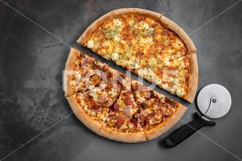 Hot italian pizza with cutter on the grey marble background. Top view and cop Stock Photos