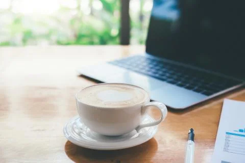 Hot latte coffee on working table. Stock Photos