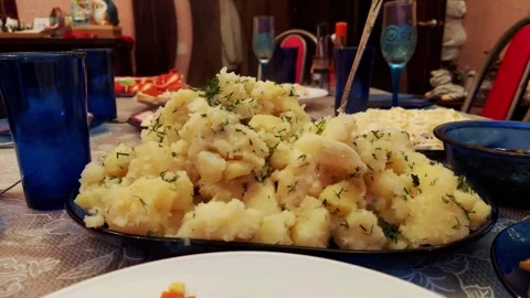 Hot mashed potatoes with dill on a festive home table with dishes and serving Stock Footage 300341295