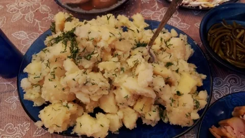 Hot mashed potatoes with dill on a festive home table with dishes and serving Stock Footage 300868077