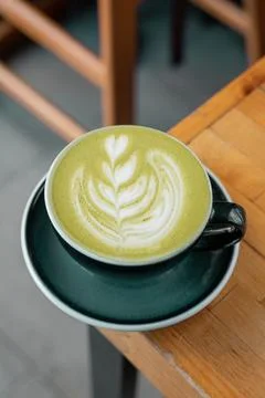 Hot matcha over a nice cup Stock Photos
