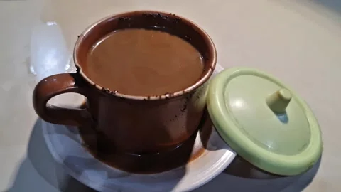 Hot Milk Coffee Served on Table with Warm Cozy Atmosphere Video stock 330790349