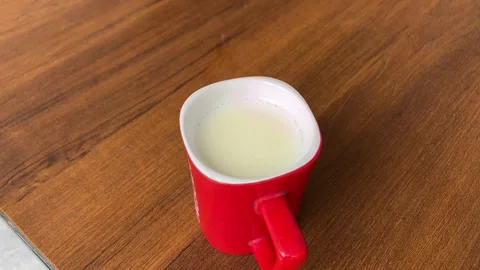 Hot Milk in Cup on Table | Fresh Warm Beverage for Health and Breakfast Vidéo 315730311