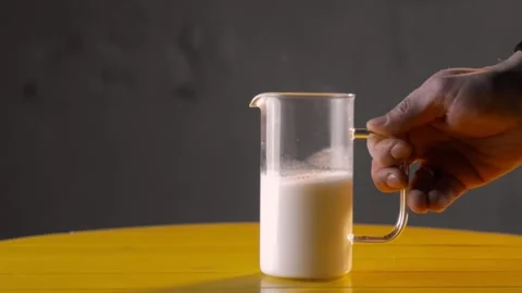 Hot milk in french press - transparent glass Stock Footage 143663053