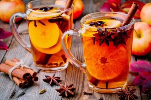 Hot mulled apple cider with cinnamon sticks, cloves and anise Stock Photos