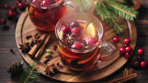 Hot mulled wine with oranges, cranberries and spices in a glass. Stock Footage 252540261