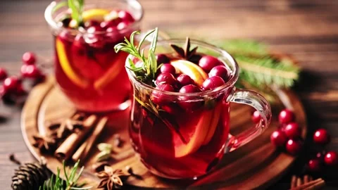 Hot mulled wine with oranges, cranberries and spices in a glass Stock Footage 253105889