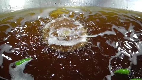 Hot Oil Bubbling in a Large Deep Frying Metal Wok for Chapli Kebabs Stock Footage 340480604