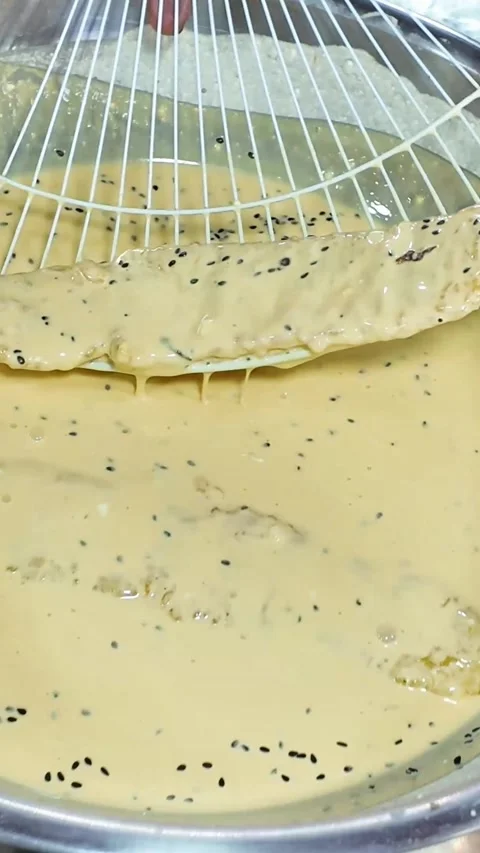 Hot Oil Bubbling While Frying Banana Batter Video stock 325598775