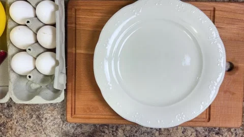 A hot omelette is placed on a white earthenware plate  動画素材 300453708