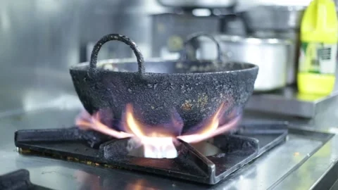 Hot pan on gas stove with high flame preparing for cooking at the restaurant. Stock Footage