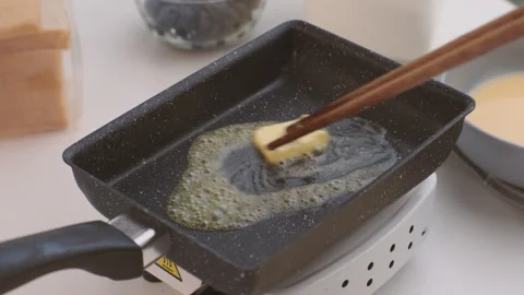 A hot pan on the stove ready for frying. Fried bread slices for breakfast. Stock Footage 242565774