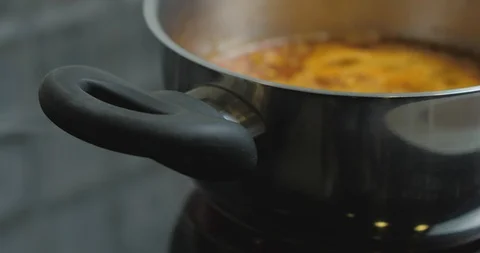Hot Pepper Chilli Sauce Is Heated And Boiled In A Pan. Cooking tomato sauce Stock Footage 128096258