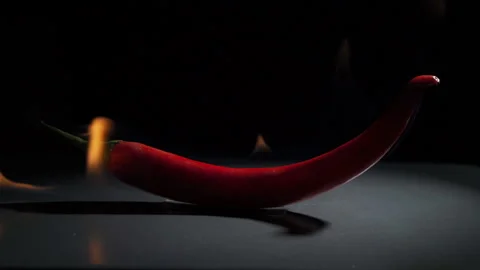 Hot pepper in flames on a black background Stock Footage 102656980