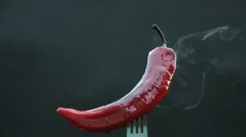 Hot pepper on a fork smokes Stock Footage 67813419