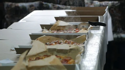 Hot pizza in boxes steams and smokes. Food delivery and catering service Video stock 130077936