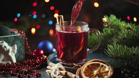 Hot punch or mulled wine for Christmas pouring in a cup 스톡 동영상 144070554