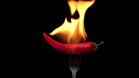 Hot red chili pepper on a fork in flames burn Stock Footage 140170822